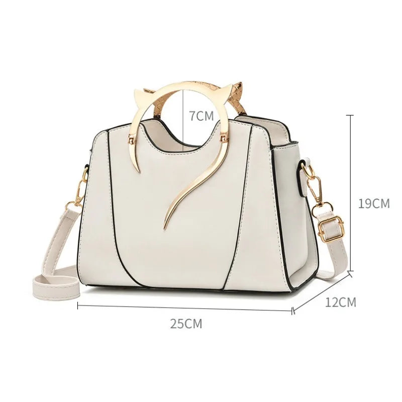 White handbag with gold accents and measurements on a white background
