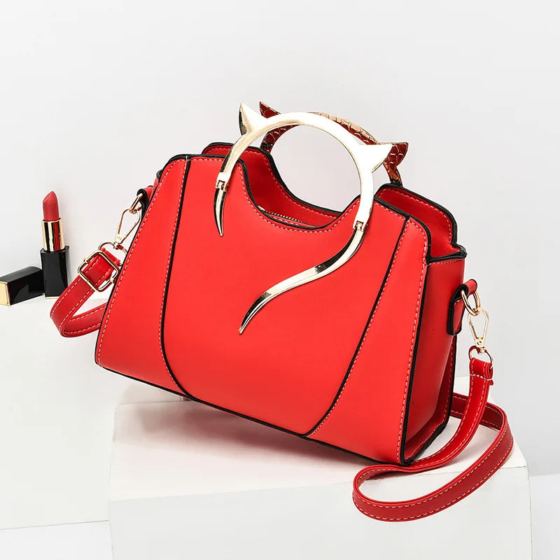 Red handbag with gold accents on a white background
