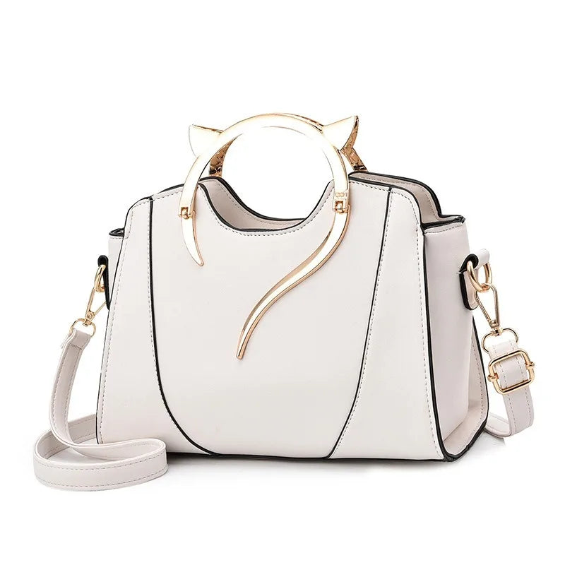 White handbag with gold accents on a white background