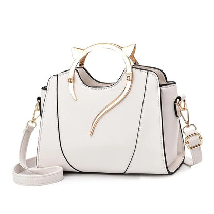 White handbag with gold accents on a white background