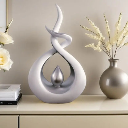 Decorative sculpture on a shelf with books and a vase in the background
