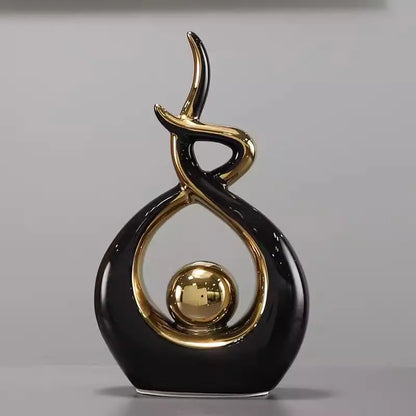 Decorative object with black and gold design on a gray background