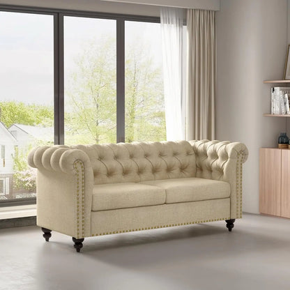 Beige sofa in a living room with large windows and a wooden cabinet.