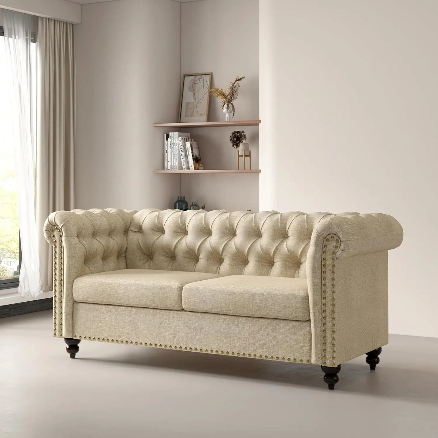 Beige tufted sofa in a room with a shelf and window