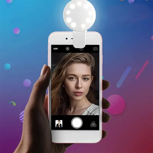 Smartphone with a selfie light attachment on a colorful background