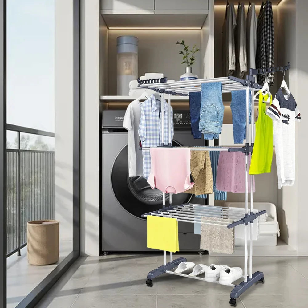 Clothes drying rack with clothes in a laundry room.