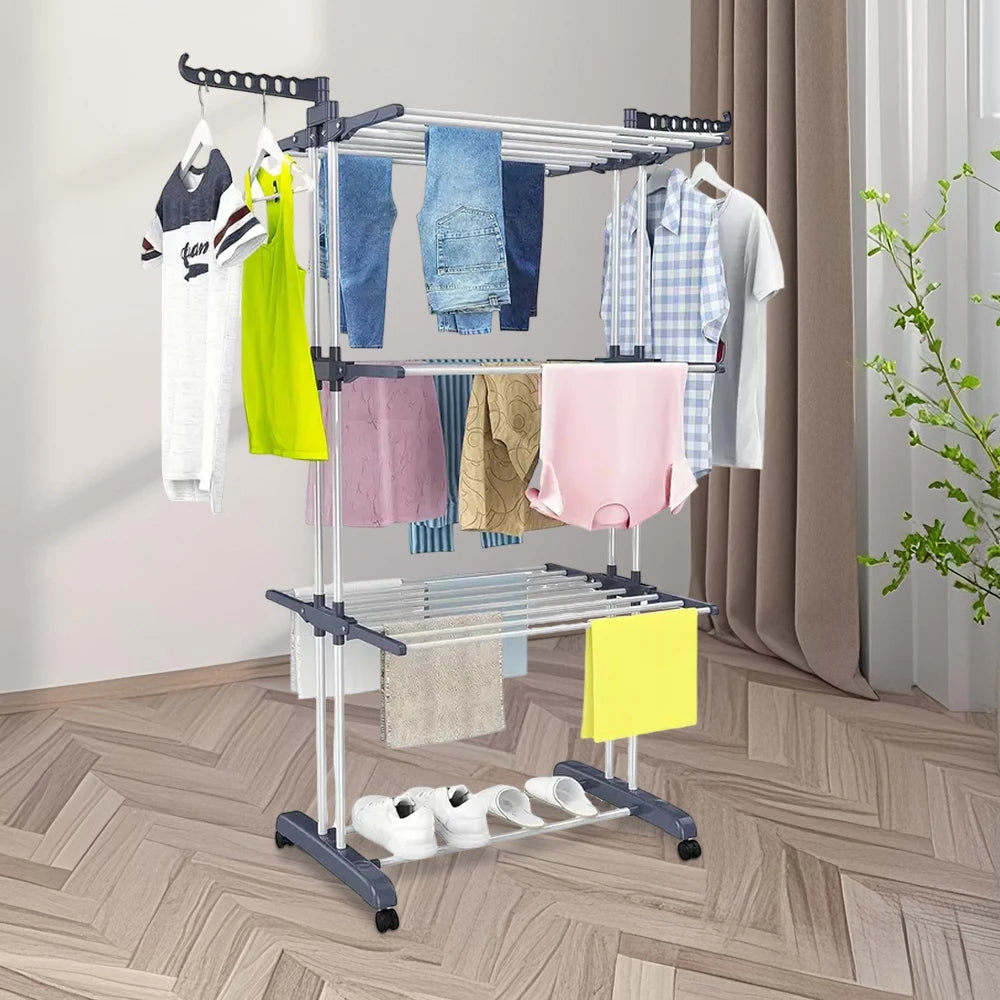 Clothes drying rack with clothes on a wooden floor.