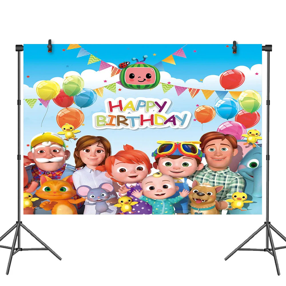 Cartoon-themed birthday backdrop with colorful balloons and characters on a stand.