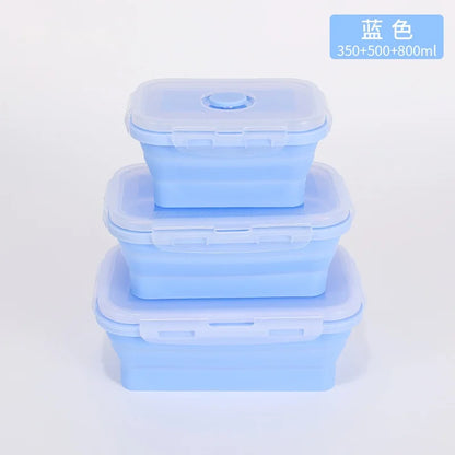 Set of three blue silicone containers with lids on a light gray background