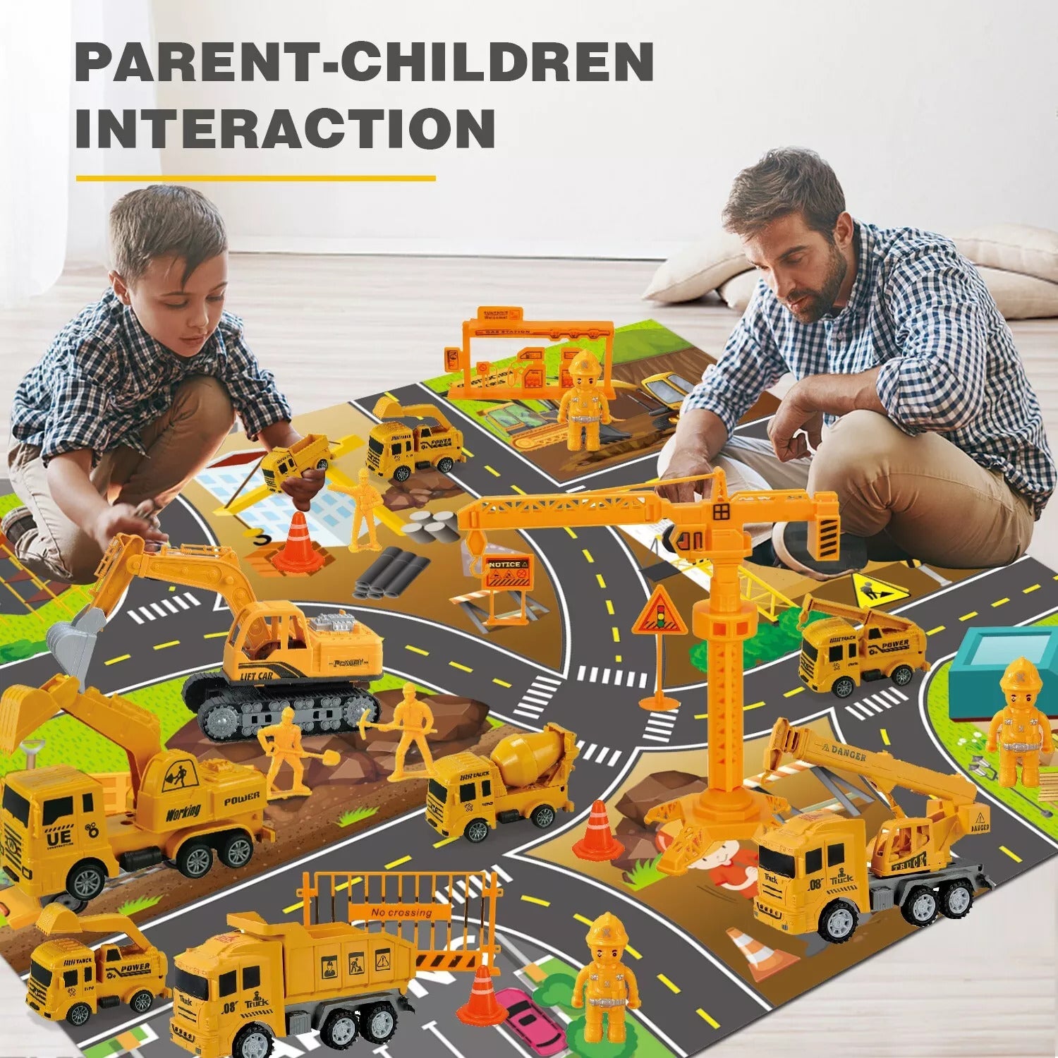 Father and son playing with toy construction vehicles on a road mat