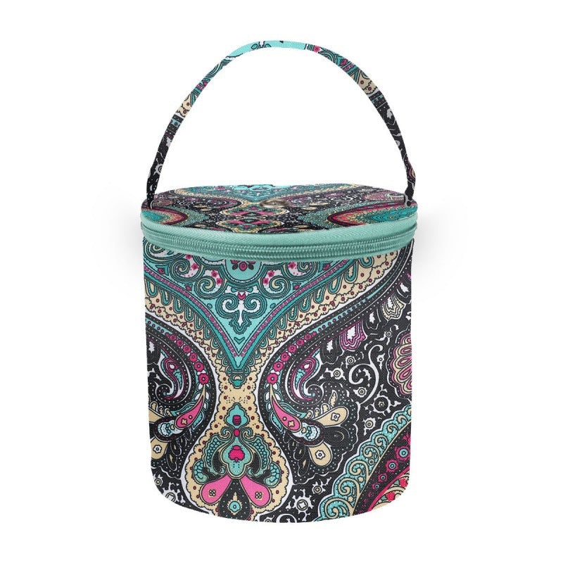 Patterned cylindrical cooler bag with a handle on a white background