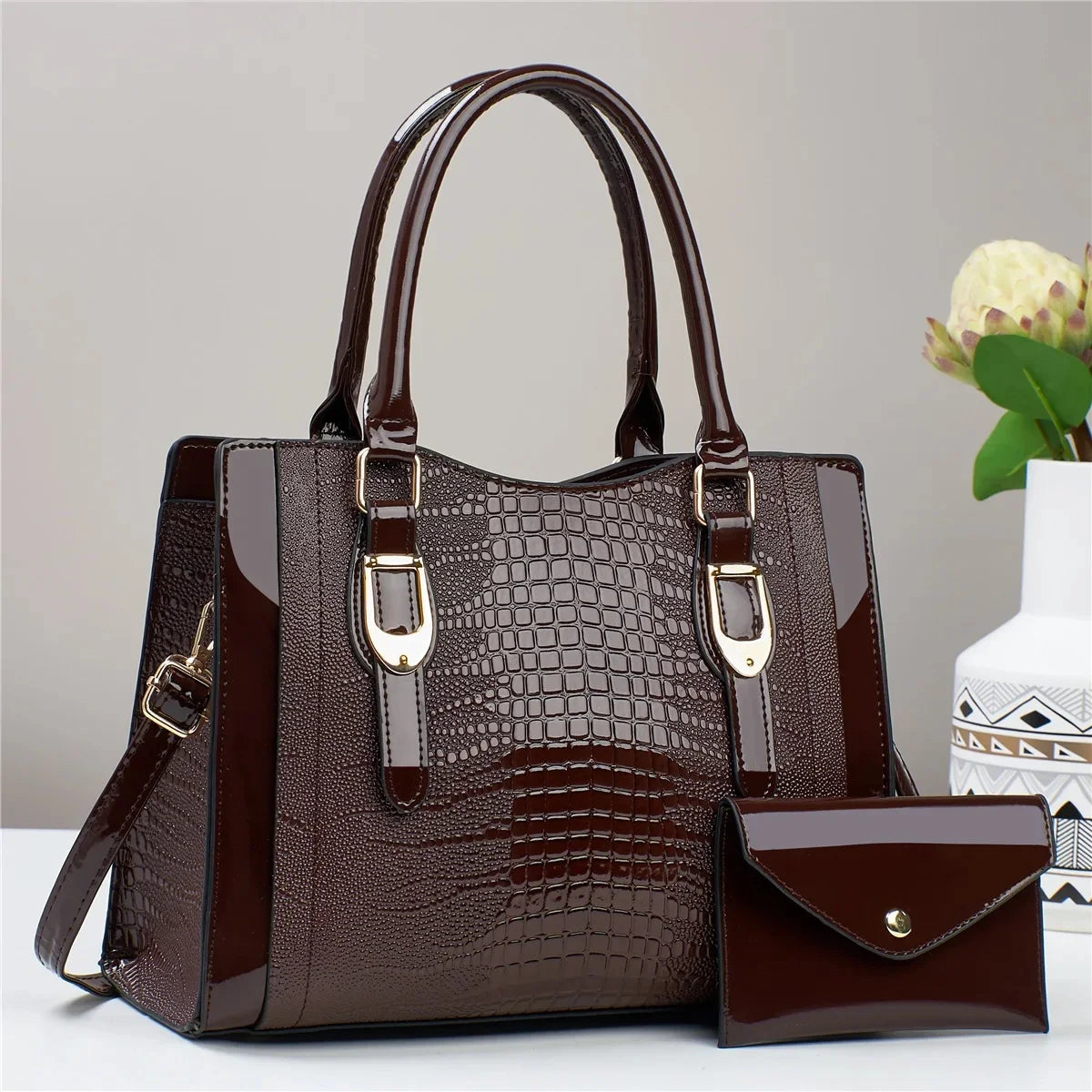 Brown handbag with gold accents on a light gray background