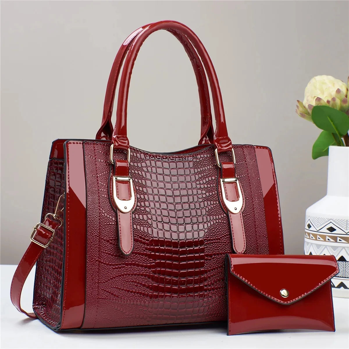 Red handbag with matching wallet on a light gray background