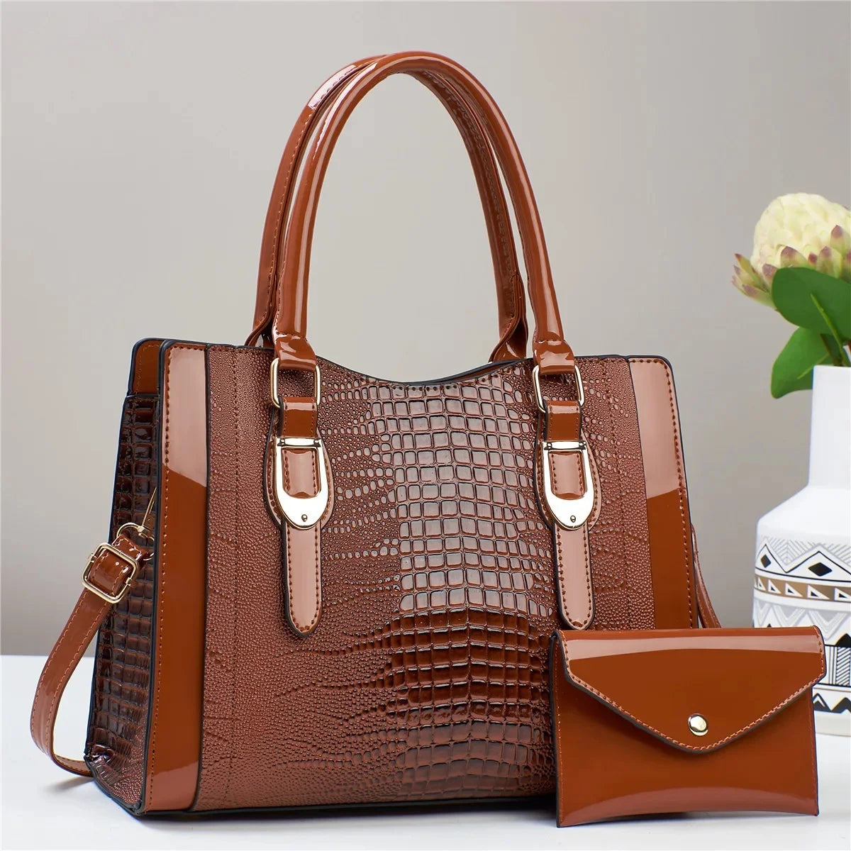 Brown textured handbag with matching wallet on a light gray background