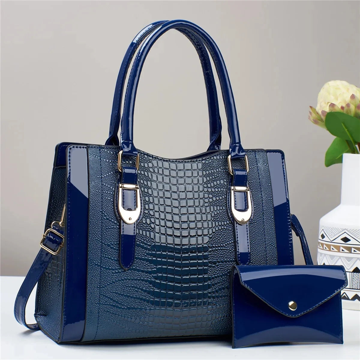 Blue handbag with a matching smaller pouch on a light gray background
