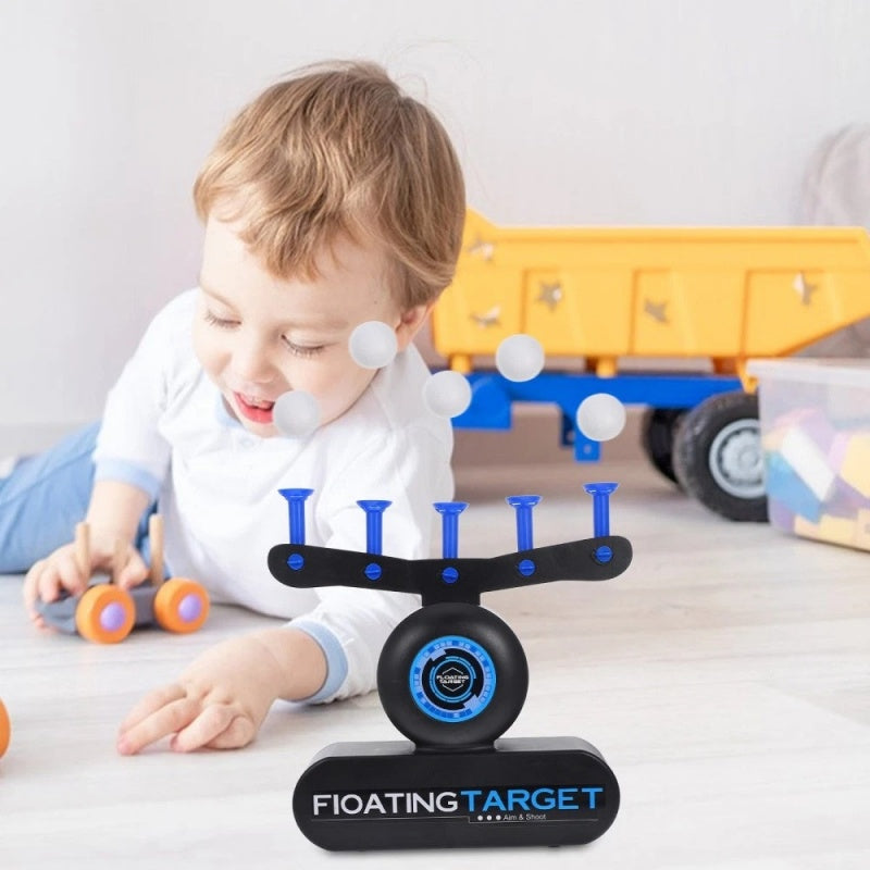 Child playing with a balancing toy called 'Floating Target' on a light surface.