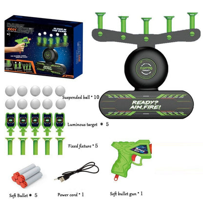 Collection of game components including a green toy gun, targets, and accessories on a white background.