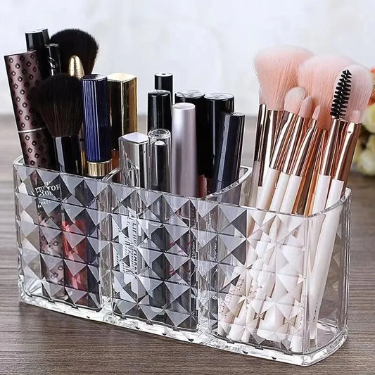 Clear diamond-patterned makeup organizer with brushes and bottles on a wooden surface.