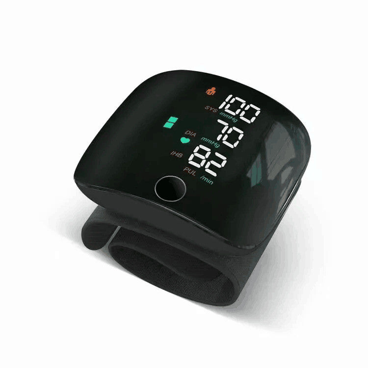 Black digital blood pressure monitor on a white background