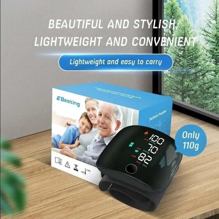 Wrist blood pressure monitor with a box featuring a family photo on a wooden surface.