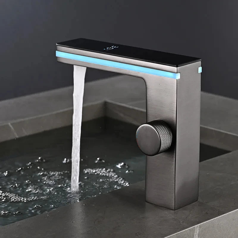 Modern faucet with water flowing on a dark surface