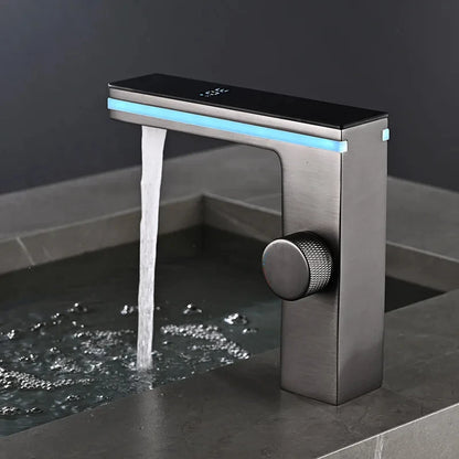 Modern faucet with water flowing on a dark surface