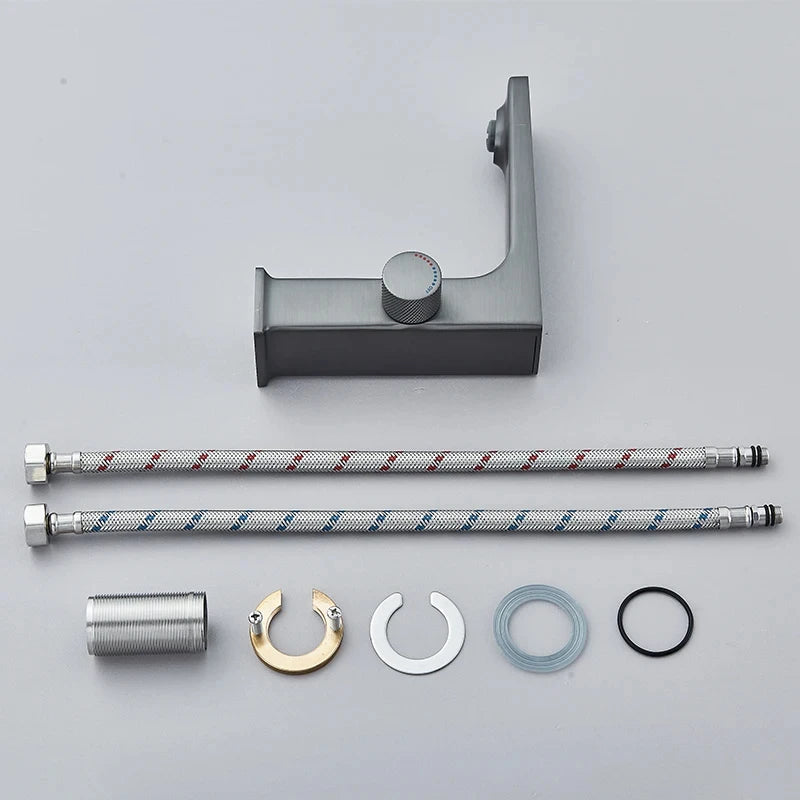 Set of plumbing components including a shower arm, brackets, and washers on a gray background