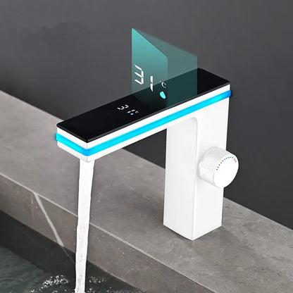 Modern bathroom faucet with digital display and water flow on a gray surface.