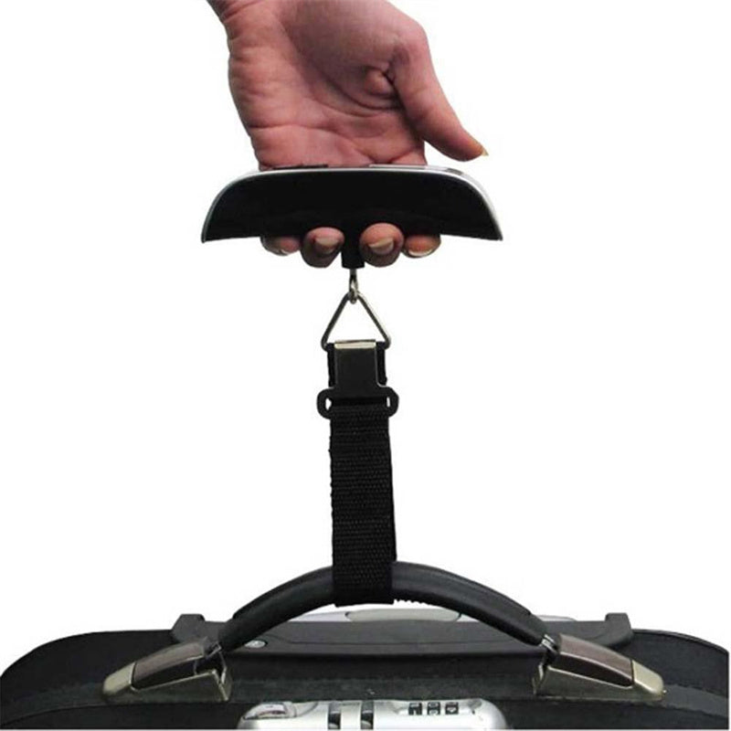 Hand holding a luggage scale above a suitcase on a white background