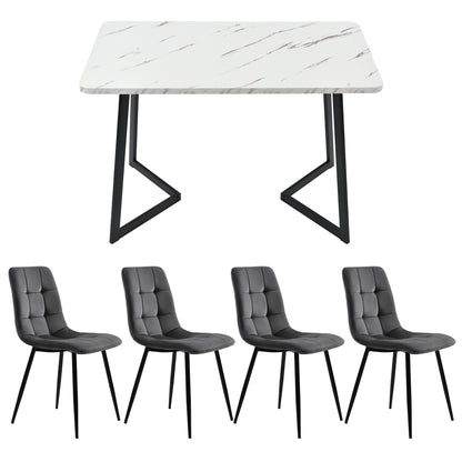 Dining table with marble-like surface and four gray chairs on a white background