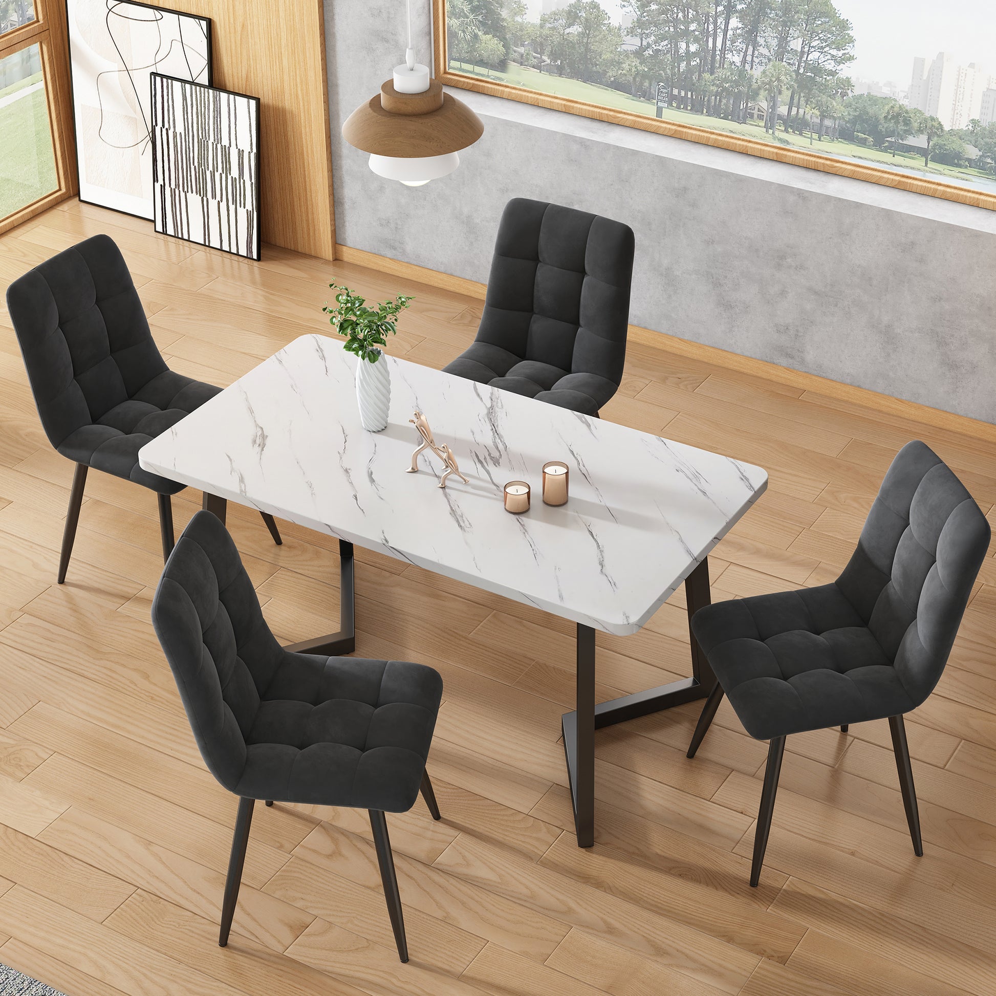 Dining room setup with a marble table and black chairs in a modern interior.