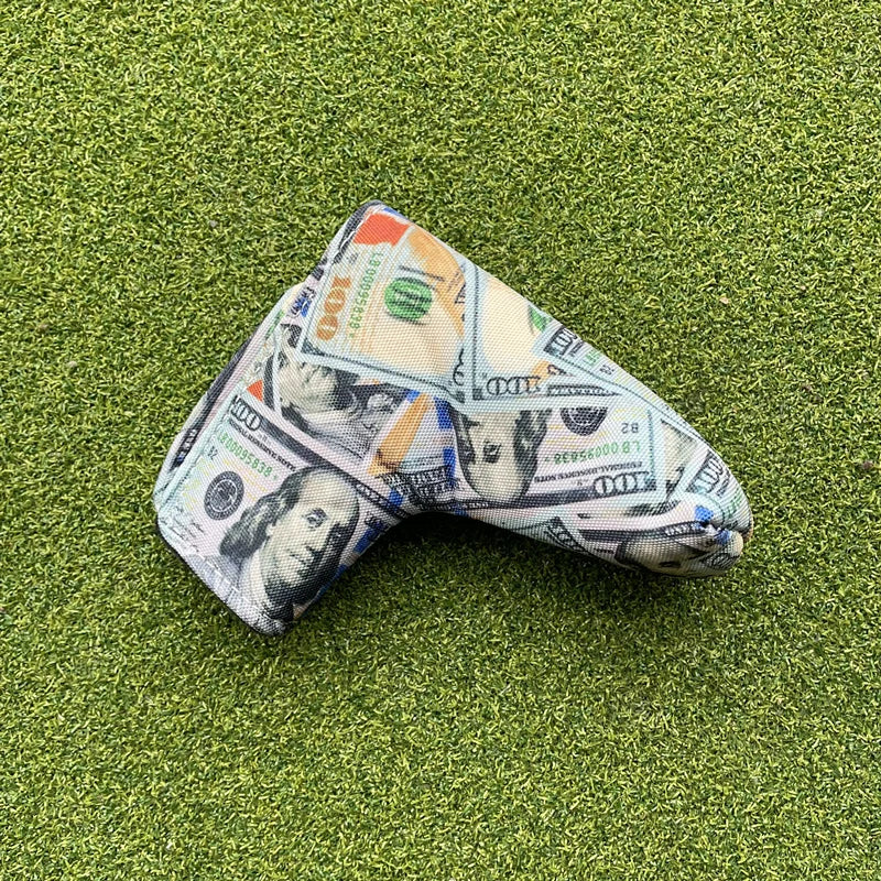 Golf club head cover with dollar bill design on a green grass background