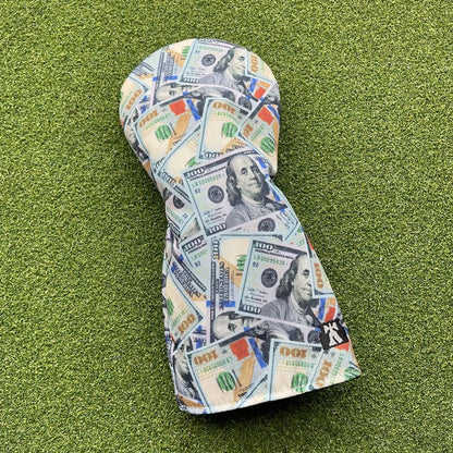 Golf club head cover with dollar bill design on a green grass background