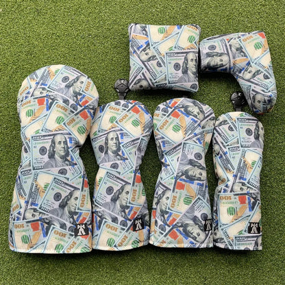 Golf club heads with dollar bill pattern on a green background