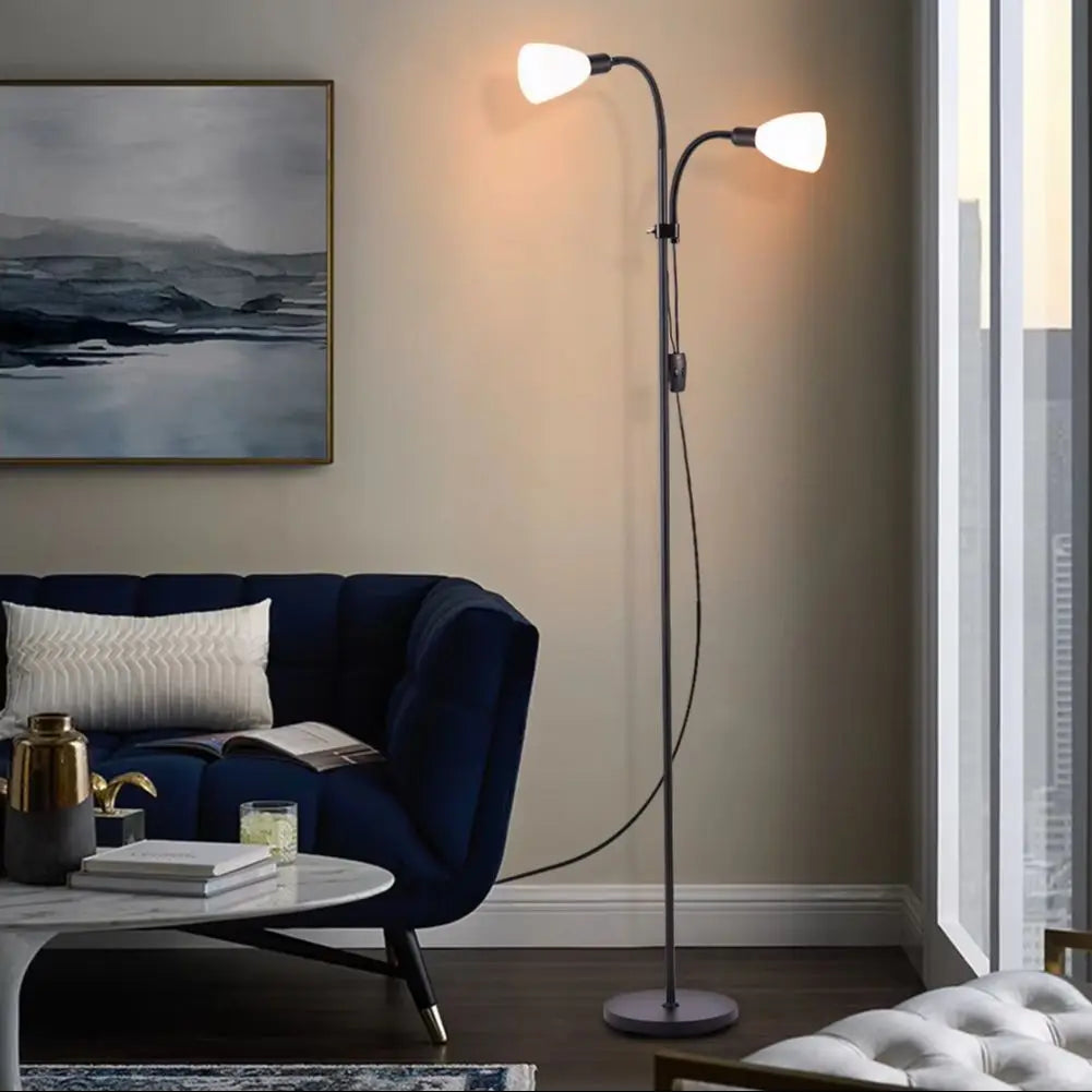 Modern living room with a dark blue sofa, round coffee table, and floor lamp.