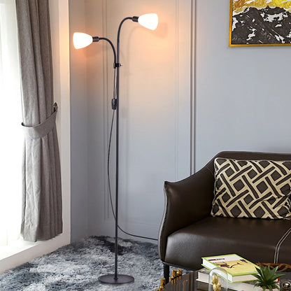 Modern floor lamp in a living room setting with a brown sofa and abstract painting.