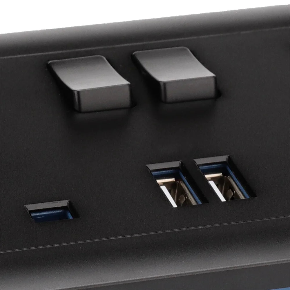 Close-up of a black electronic device with two switches and two USB ports.