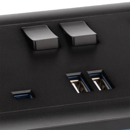 Close-up of a black electronic device with two switches and two USB ports.