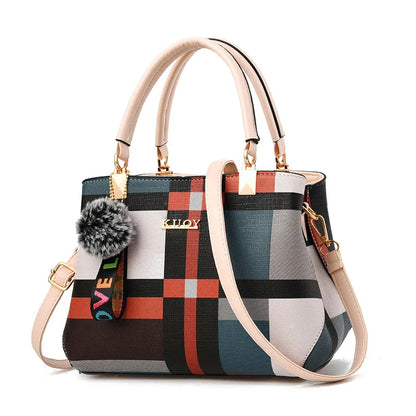 Multicolored handbag with plaid pattern and decorative strap on a white background