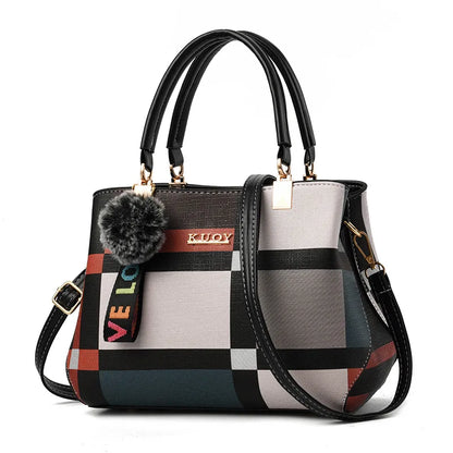Multicolored checkered handbag with a pom-pom detail on a white background