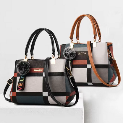 Two patterned handbags with pom-poms on a light gray background