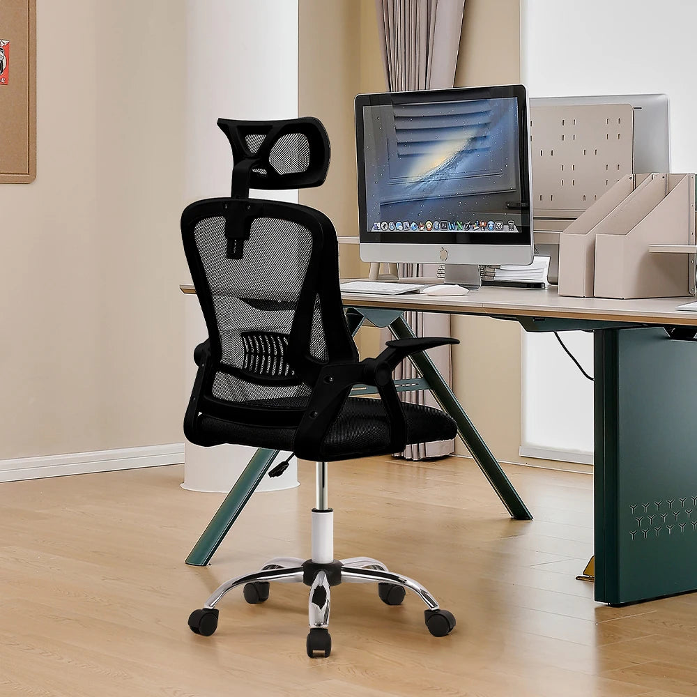 Black office chair in front of a desk with a computer setup.