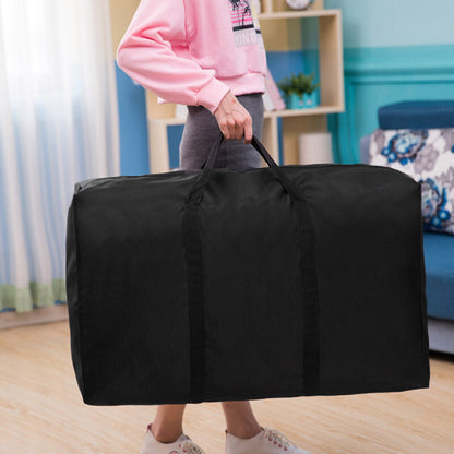 Person holding a large black duffel bag in a room with a blue wall and white curtains.