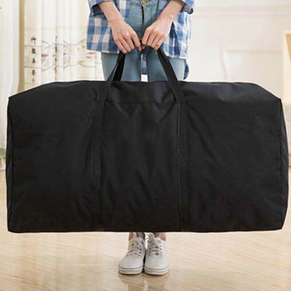 Person holding a large black duffel bag indoors