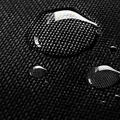 Close-up of a textured black surface with water droplets.