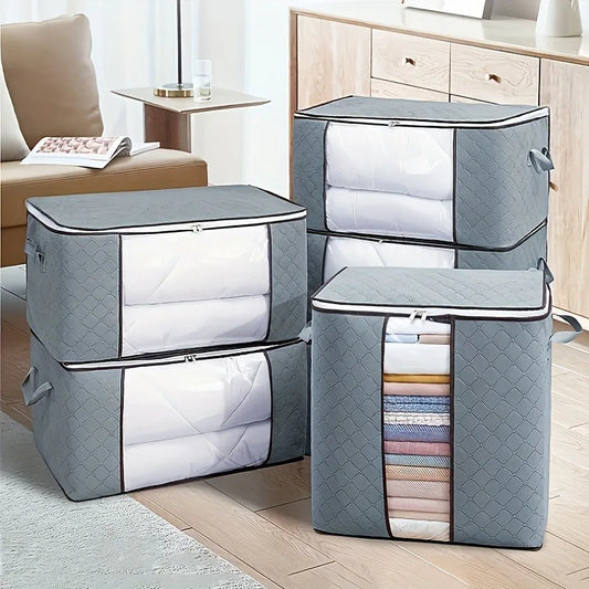 Set of gray storage boxes with quilted design on a wooden floor.