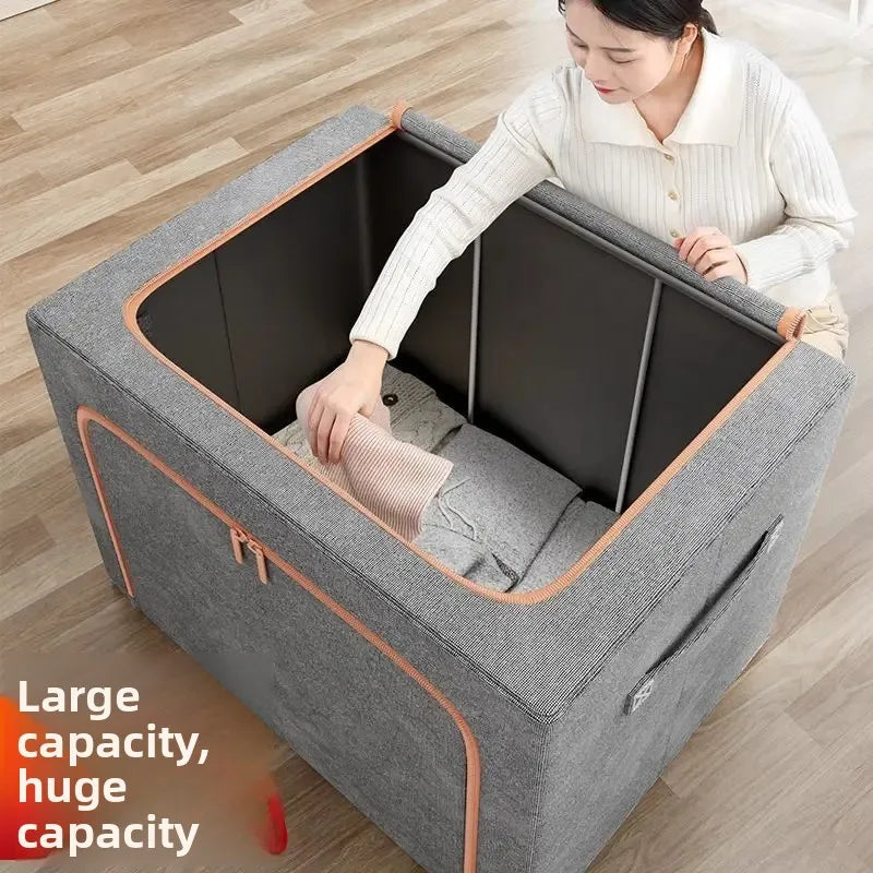 Person interacting with a large gray storage ottoman on a wooden floor.