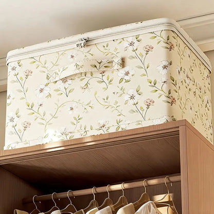 Floral-patterned storage box on a wooden shelf with clothes hanging below