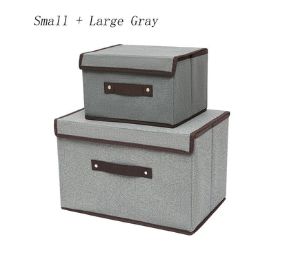 Two gray storage boxes with brown handles on a white background