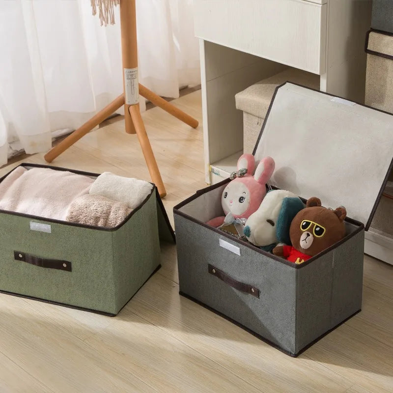 Two storage bins, one green and one gray, with stuffed toys on a wooden floor.